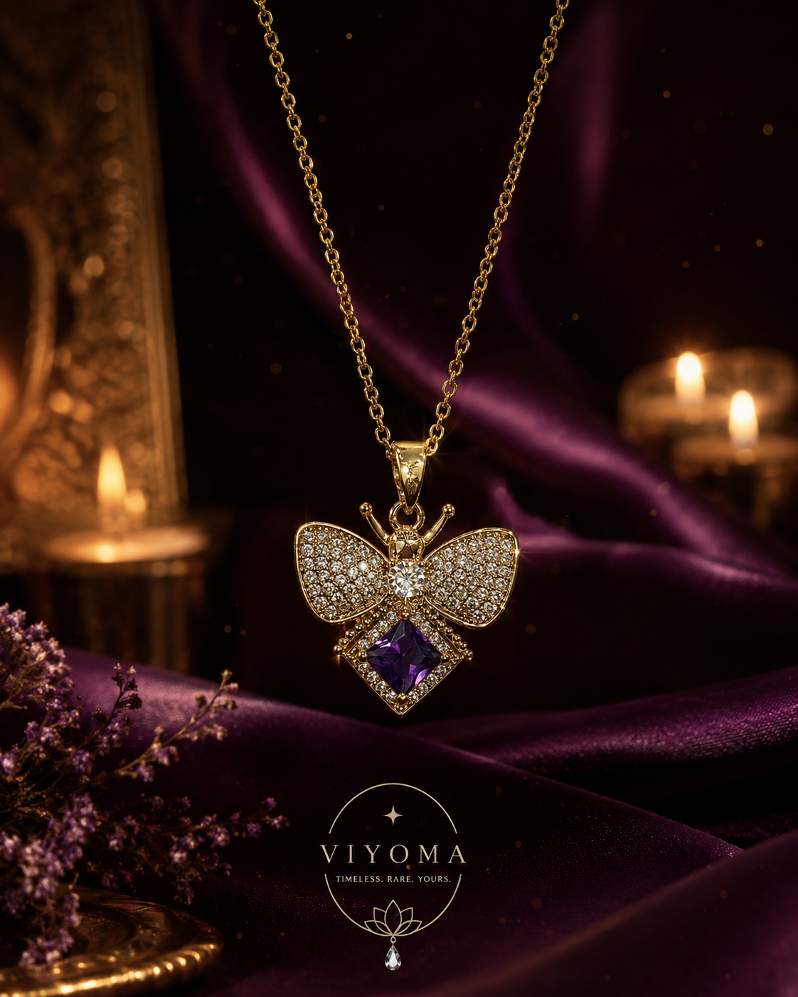 VIYOMA Amethyst Flutter Pendant displayed on rich purple satin with sparkling crystal detailing and a brilliant amethyst-purple gemstone centerpiece.