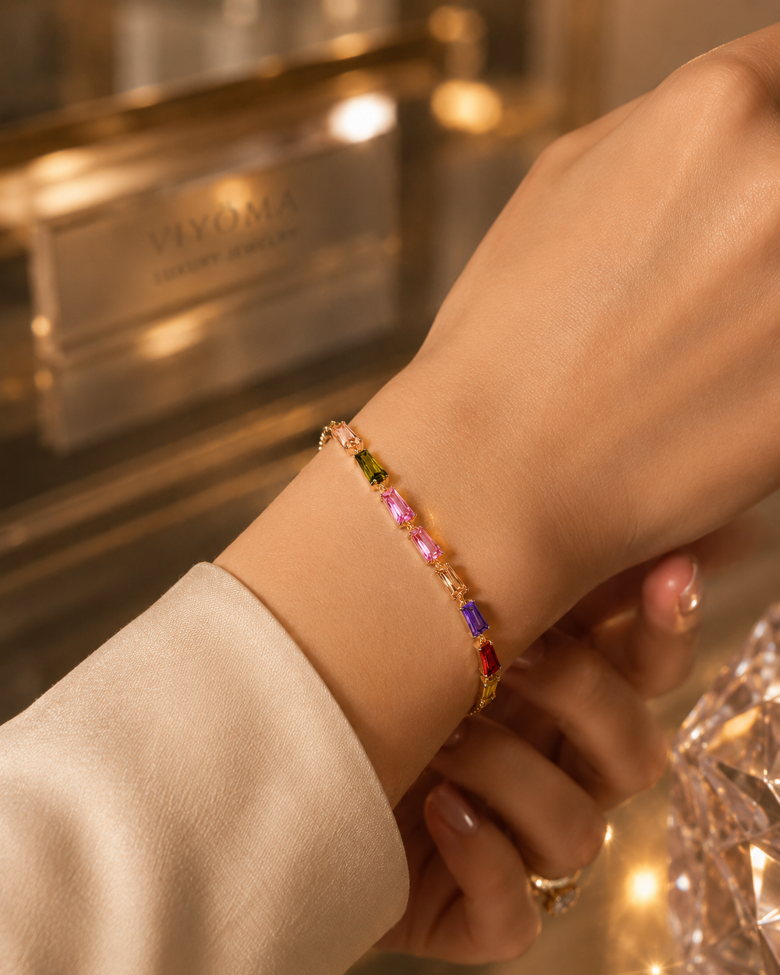Close-up of the VIYOMA Prism Line Bracelet on a model's wrist, highlighting vibrant multicolor crystals in an elegant gold-tone setting.