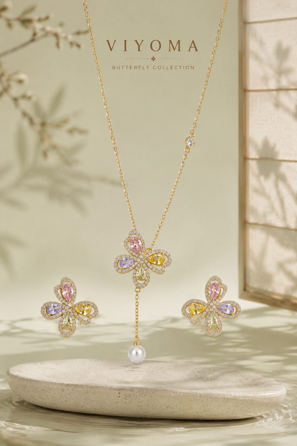 VIYOMA Pastel Papillon Set featuring a crystal butterfly pendant necklace with pearl drop and matching pastel butterfly earrings in an elegant display.