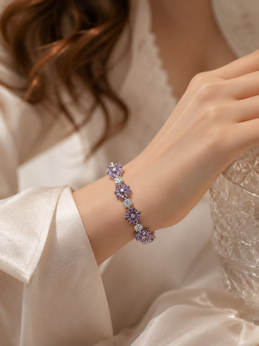 Close-up of the VIYOMA Lavender Reverie Bracelet worn on the wrist with a satin sleeve, highlighting lavender crystal flower details and brilliant sparkle.