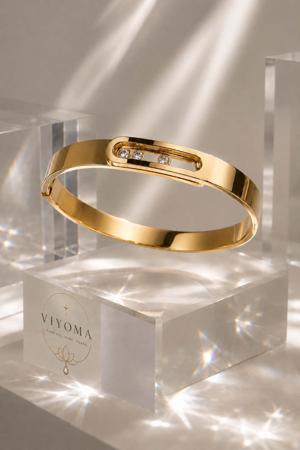 VIYOMA Starlight Trinity Cuff in anti-tarnish gold finish displayed on crystal blocks, featuring three floating crystal stones and a minimalist luxury design.