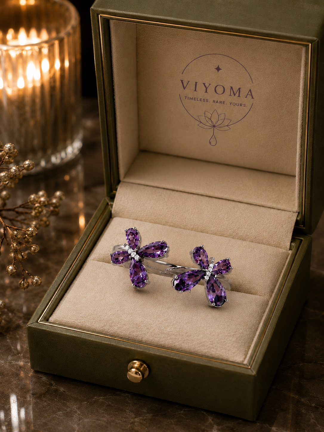 VIYOMA Butterfly Rift Ring presented in a premium olive-green jewelry box with soft champagne interior, showcasing its adjustable open-band design and violet crystal butterfly motifs.