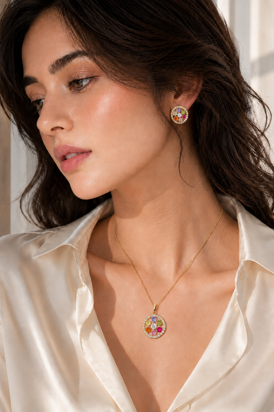 Model wearing the VIYOMA Carnival Bloom Set with a white satin blouse, featuring a colorful crystal pendant necklace and matching statement earrings.