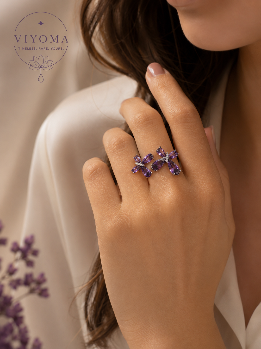 Model wearing the VIYOMA Butterfly Rift Ring featuring twin butterfly-inspired violet crystal motifs on an adjustable silver-tone open band, styled elegantly against a soft neutral background.